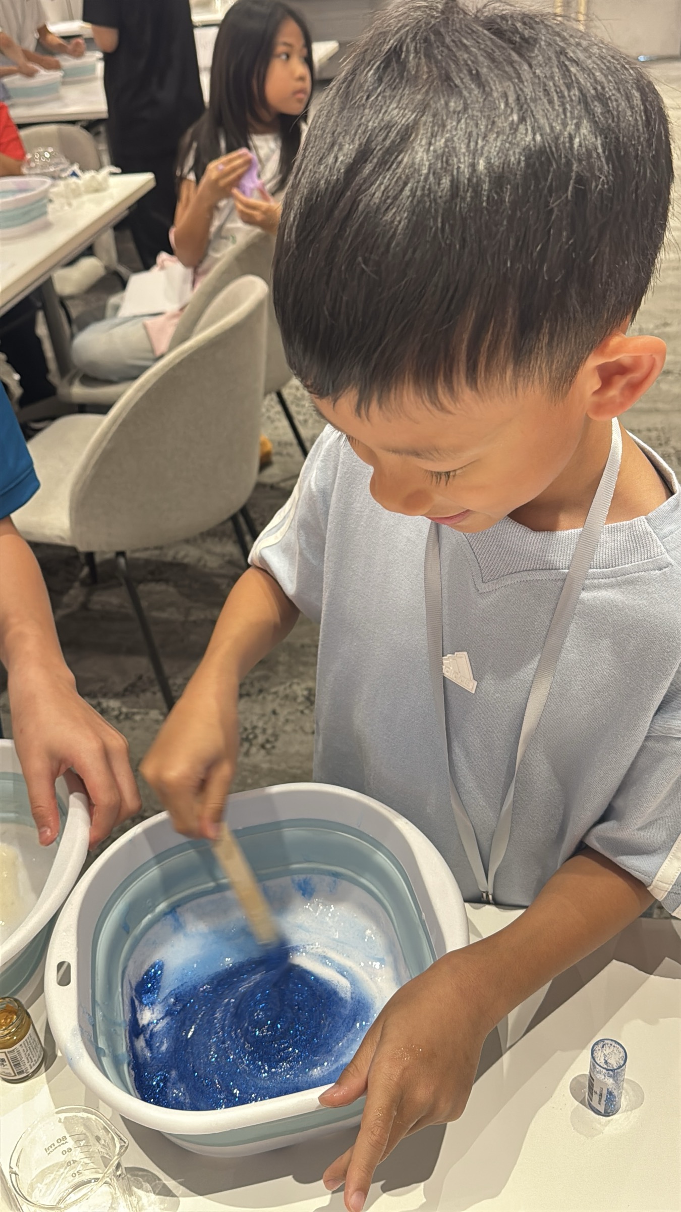 Child fully focused, creating at Sentient Minds Camp