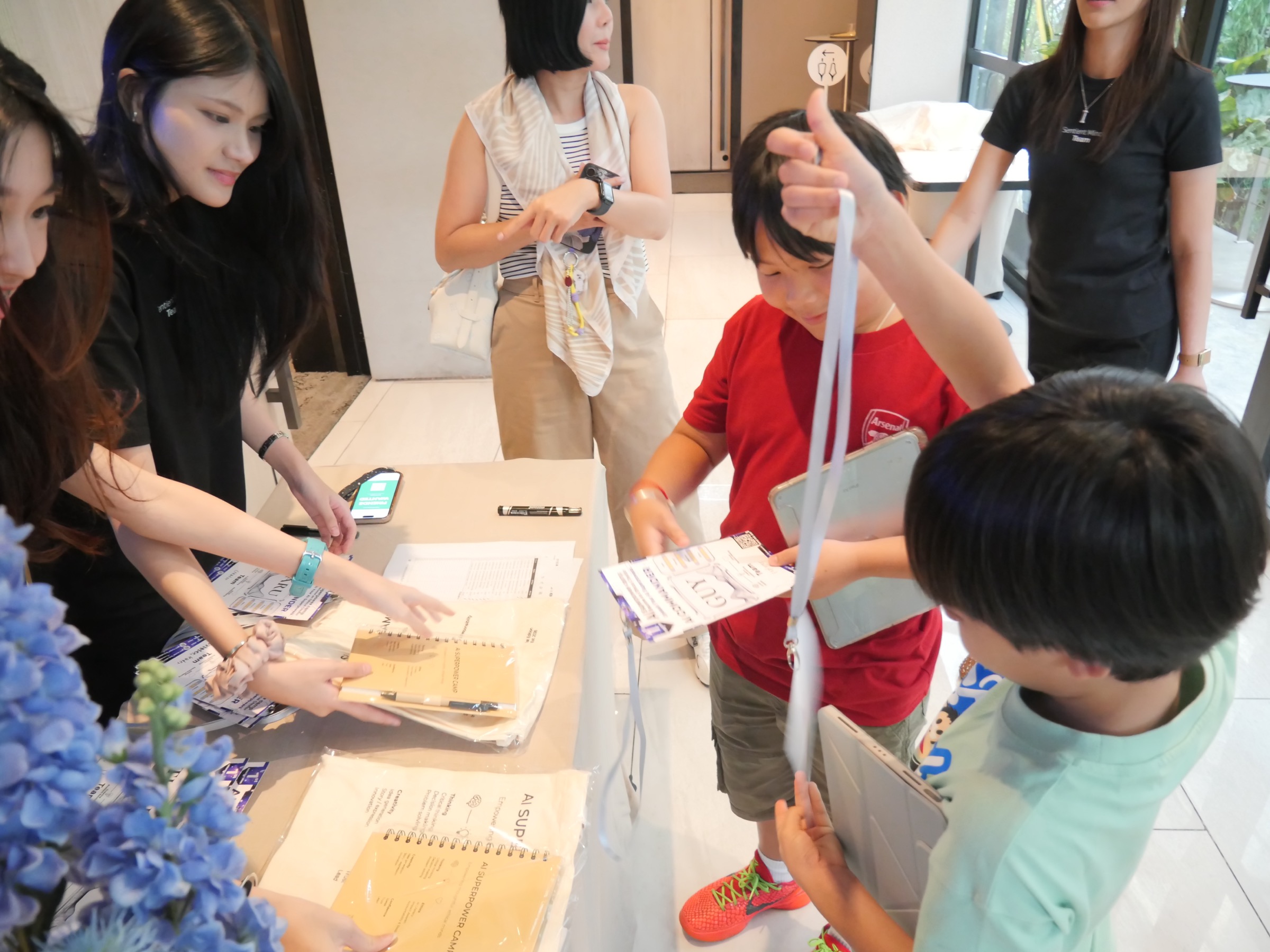 Camp welcome registration — Sentient Minds team greeting children